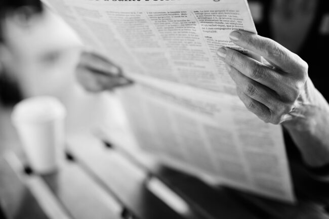 Newspaper,Broadsheet,Held,And,Read,By,Senior,Female