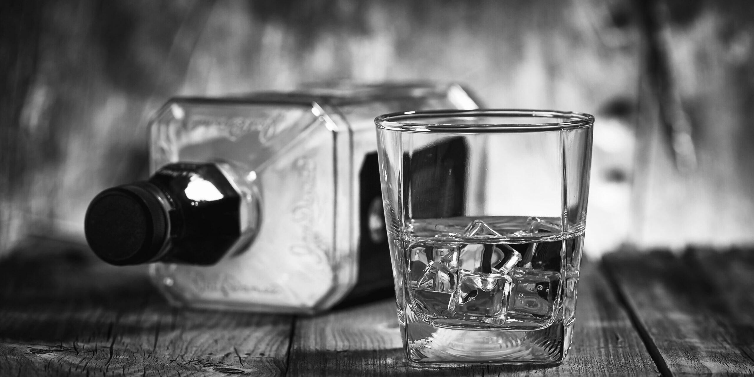 A,Glass,Of,Whiskey,And,Empty,Bottle,Of,Whiskey,On