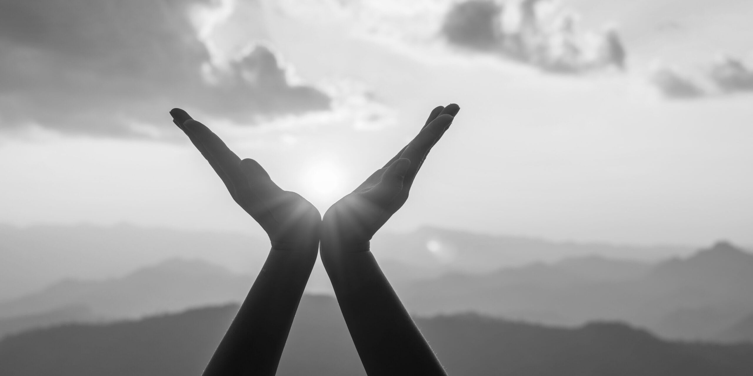 Silhouette,Female,Hands,Holding,Sun,On,Mountain