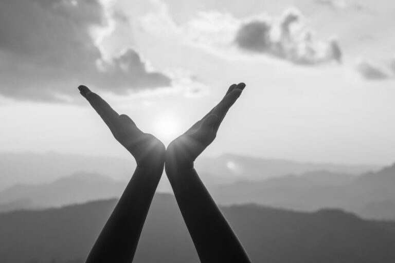 Silhouette,Female,Hands,Holding,Sun,On,Mountain