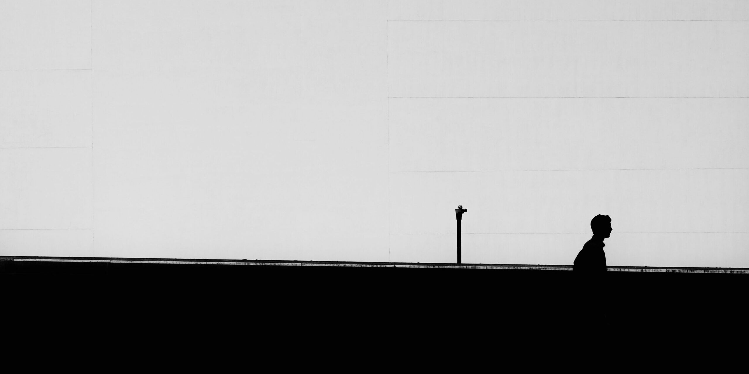 Horizontal silhouette of a lonely male under the clear sky